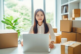 Fototapeta Sport - Energetic Asian Entrepreneur Packaging Orders in Home Office