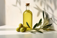 Commercial Photography, Glass Bottle Of Olive Oil With Olive Branch Isolated On Flat Color Wall Background With Copy Space.