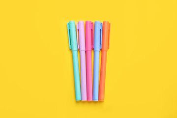 Poster - Many colorful markers on yellow background, flat lay