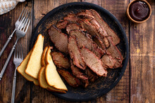 Sliced Smoked Brisket On A Serving Plate With Toast
