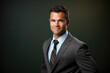 © aicandy - Captivating Male Entrepreneur in a Professional Suit and Tie, Smiling Confidently at the Camera against a Teal Background