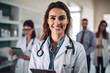 © AspctStyle - Portrait of smiling female doctor standing in hospital holding digital tablet
