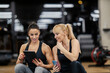 © Dusan Petkovic - A happy female coach is showing progress on tablet to a sportswoman who is sitting next to her.