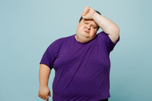 Young Sick Ill Sad Tired Chubby Overweight Man Wearing Purple T-shirt Casual Clothes Put Hand On Forehead Suffer From Headache Isolated On Plain Pastel Light Blue Cyan Background. Lifestyle Concept.