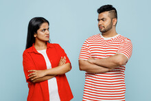 Dissatisfied Young Offended Frowning Couple Two Friends Family Indian Man Woman Wear Red Casual Clothes T-shirts Together Hold Hands Crossed Folded Isolated On Pastel Plain Blue Cyan Color Background