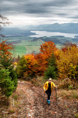 Wall Mural - Girl hiker on autumn moutain trail