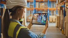 Futuristic Technology Warehouse Concept: Female Worker Doing Inventory, Using Augmented Reality Application On Tablet. Woman Analyzes Digitalized Products Delivery Infographics In Distribution Center.
