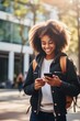 Happy African Black teen girl college generation z student with backpack looking at smartphone using mobile cell phone modern tech device standing in university campus. generative AI