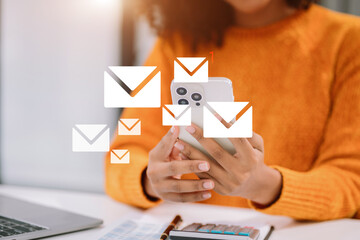 Email notification concept, Female use smartphone and laptop receive message alert in the mailbox.