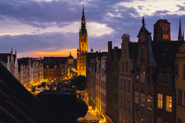 Wall Mural - Beautiful old town in Gdansk at summer dusk Poland. Sunset night view from the window rooftop on historical centre Dluga street and city hall architecture buildings St Mary Basilica. Travel attraction