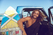 © Marko Geber - Portrait of a young male surfer sitting in a car and getting ready to go out surfing in the ocean