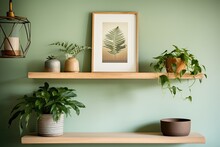 Green Wall Mounted Photo Frame On Wooden Shelf With Plants.