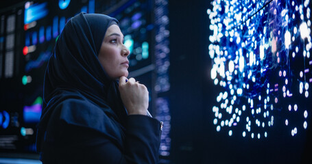 Leinwandbilder - Portrait of a Thoughtful Middle Eastern Software Developer Working in Technological Corporate Office. Young Woman Testing Artificial Intelligence Algorithms for an Innovative Internet Project