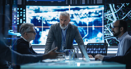 Fototapete - Diverse Group of Cybersecurity Experts Monitoring an Active Operation with Satellite Tracking Technology. Surveillance Office with Multiethnic Specialists Tracking a Target Vehicle in Urban Terrain