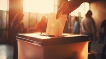 Hand Putting Letter In Ballot Box With Blur People  Background 