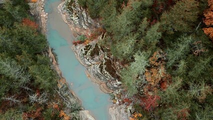 Wall Mural - Aerial drone flying over Arkansas, ozark mountains and green streaming river in autumn with fall colored forest leaves
