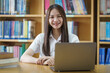 © EduLife Photos - Portrait of an Asian girl college student studying in library doing project assignment and preparing for examination