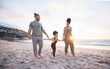 Holding hands, family and walk on beach at sunset, bonding and mockup space. Father, mother and happy kid at ocean in interracial care, love or smile on vacation, holiday or summer travel together
