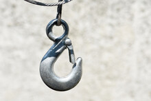 A Steel Hook Hangs On A Cable.