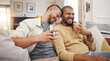 © Wesley/peopleimages.com - Laughing, relax and a gay couple on the sofa with coffee, conversation or love in a house. Happy, together and lgbt men on the living room couch for a funny story, communication or speaking with tea