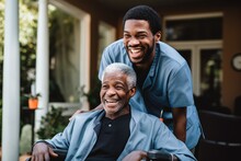 Young Male Caregiver Pushing A Senior Man In His Wheelchair In A Nursing Home Smiling And Laughing