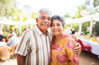 Portrait of a happy smiling Mexican senior couple at family gathering outdoors