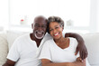 © Jasmina - Portrait of a happy, smiling black senior couple at family gathering indoors