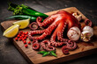 Fresh raw squid  with ingredients on wooden background