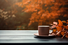 Coffee Cup Nestled Among Autumn Leaves On A Wooden Table, With A Softly Blurred Fall Autumn Background. High Quality Photo
