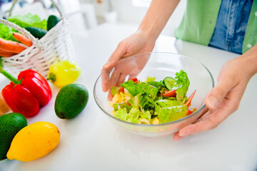 Wall Mural - Cropped photo of young girl arms wear green shirt preparing tasty fresh salad indoors kitchen room