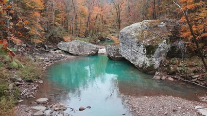 Wall Mural - Beautiful pool of water and large boulder in Arkansas ozark mountain river via aerial drone in fall with autumn forest 