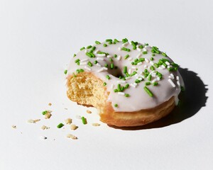 Poster - Close up of a half-eaten glazed doughnut with green sprinkles