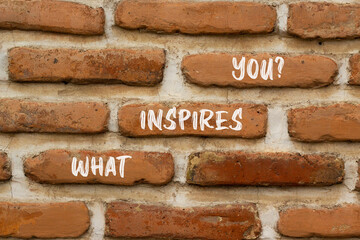 What inspires you symbol. Concept words What inspires you on beautiful brown brick. Beautiful red brown brickwall background. Business motivational what inspires you concept. Copy space.