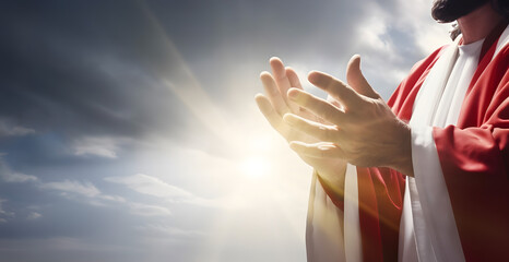 Jesus Christ reaching out hand and praying against sunshine.