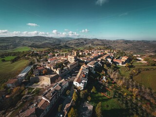 Sticker - Aerial shot of the beautiful buildings of the medieval Tavoleto village in Italy on a sunny day