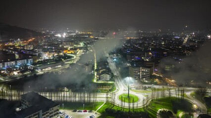 Wall Mural - Drone hyper-lapse over city with fireworks and lights  at night