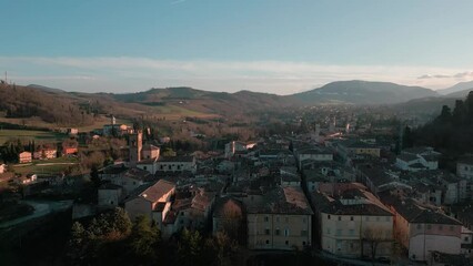 Poster - Aerial footage over traditional houses with trees in an Italian village at sunset