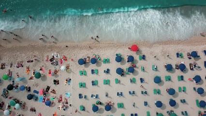 Sticker - Aerial top view video of sun loungers, beach umbrellas and people on the sea shore