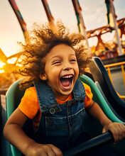 Boy Or Child Riding A Roller Coaster In An Amusement Park. Screaming As The Ride Goes Fast. Motion Blur.
