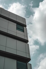 Sticker - Vertical shot of a abstract modern building on a sunny day under the blue sky in Korea