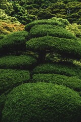 Sticker - Vertical shot of a majestic Japanese garden covered in flowers and greenery in Japan