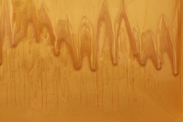 Wall Mural - Gold and bronze glitter color flow liquid painting wall background.