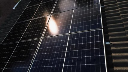 Poster - Photovoltaic modules panels on a private house roof, colorful summer dusk - Aerial view