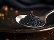 A spoon filled with black caviar on a bed of black caviar.
