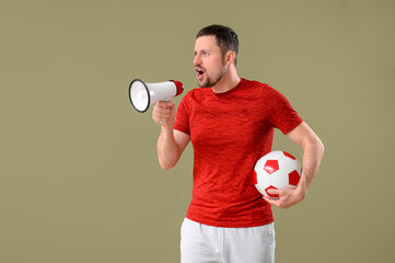 Wall Mural - Man with soccer ball and megaphone on color background