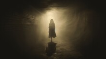 A Vintage Sepia Grunge Edited Image Shows A Ghostly Woman In A Dress In A Foggy Tunnel At Night. Silhouette Concept