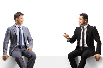 Wall Mural - Businessmen sitting on a blank panel and having a conversation