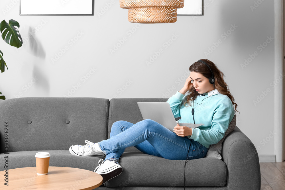 Female technical support agent with laptop working at home