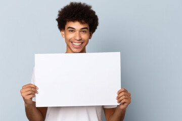 Your creativity's canvas: an empty paper sheet in man's hands with space for text.