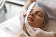 © Demetr White/Stocksy - Doctor works with patient in dermatology clinic